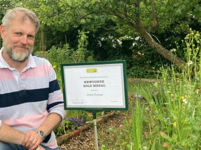 Jon next to a best newcomer award