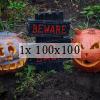 Two carved pumpkins and a sign between them "Beware", "Go back"